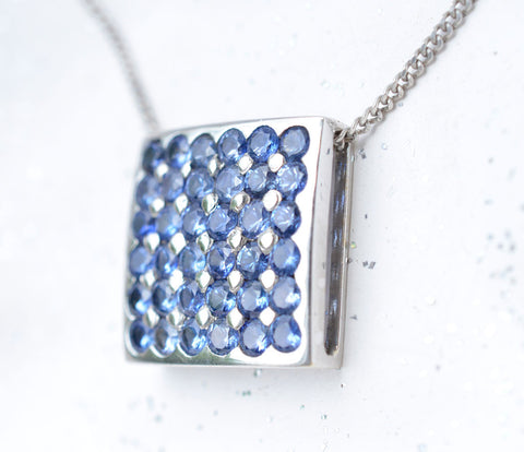 Square pendant with Ceylon blue sapphires paved in 18K white gold