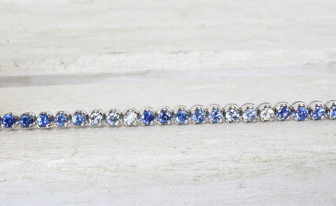 Singe flexible straight line design sapphire bracelet with different hues of natural Ceylon blue and white sapphires