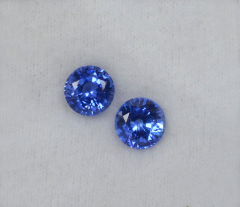 A pair of medium blue round shaped blue sapphires