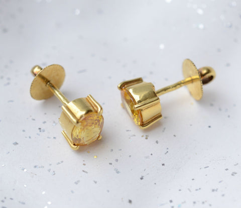bezel set yellow sapphire ear studs in 18K yellow gold